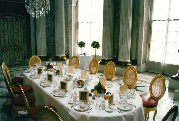 The table is laid in the Marble Hall at Sanssouci Palace